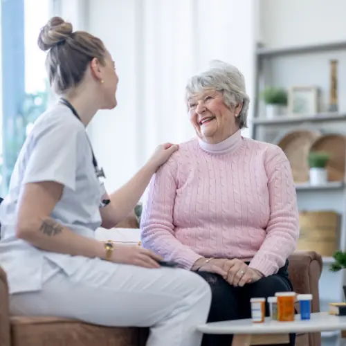 Professional caregiver providing friendly in-home assistance as part of trusted Home Care Support Services for an elderly woman.